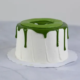 a white cake with green icing