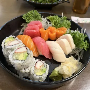 Sushi and sashimi lunch special. Seaweed salad in the background.