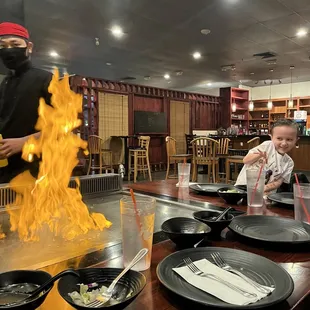 a man in a ninja costume cooking food