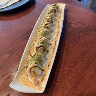 Green dragon roll imitation crab and tempura shrimp inside topped with eel sauce and spicy mayo