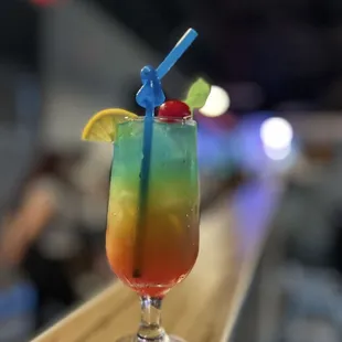 a colorful drink on a bar