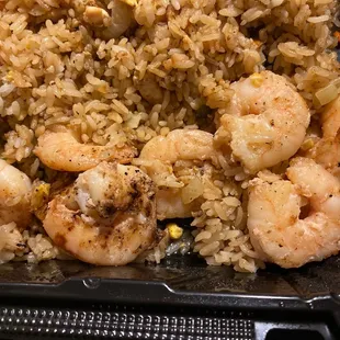 shrimp and rice in a black container
