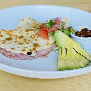 a plate of food including a quesadilla
