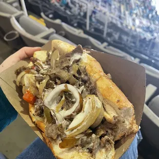 a person holding a sandwich