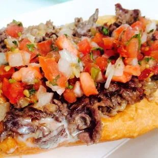 This is the Muy Bueno: Ribeye, Amoroso Roll, Pico De Gallo, Cilantro Creama with Cotija Cheese