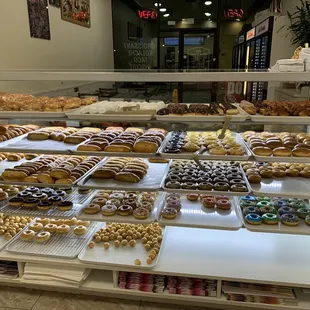 Variety of kolaches, breakfast croissant, breakfast taco and donuts.