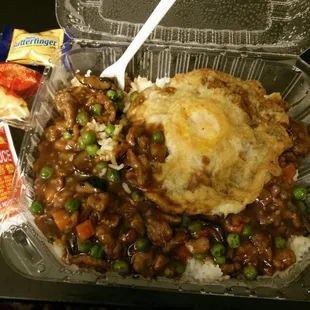 Minced beef with peas over rice with a fried egg on top