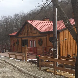 a wooden building with a red roof