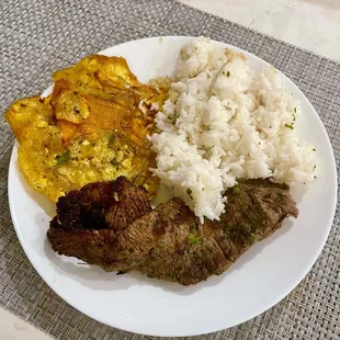 Flank Steak with sides of fried Plantains and rice