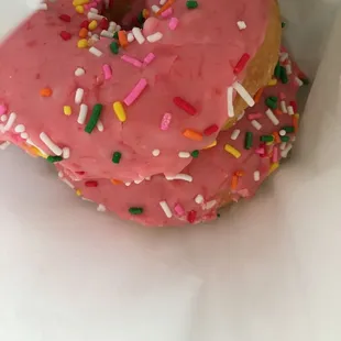 a pink donut with sprinkles