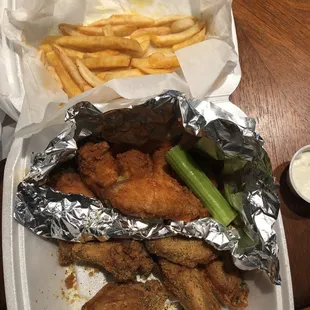 Lemon pepper and hot wings with fries to-go