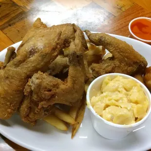 Whole chicken wings with hushpuppies fries and a side of mac and cheese. including a side of buffalo sauce