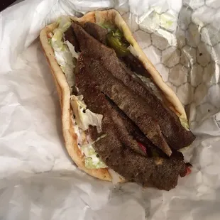 a steak sandwich in a wrapper
