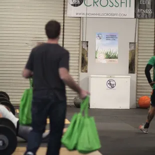 a man carrying a green bag
