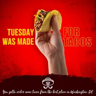 a hand holding a taco