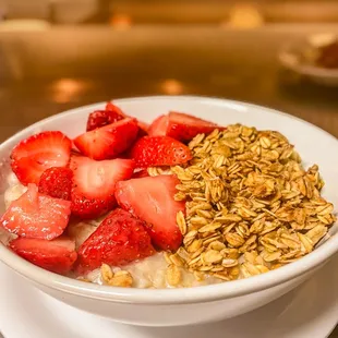 a bowl of oatmeal and strawberries
