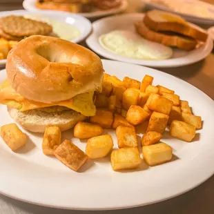 a bagel sandwich and fries