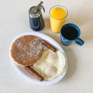 a breakfast of eggs, sausages and pancakes