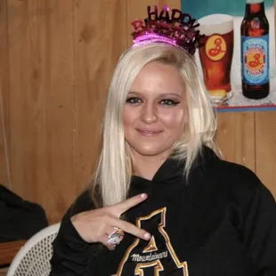 a blonde woman in a black shirt and tie