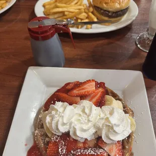 Fruit waffle and cheeseburger with fries