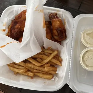 10 piece wings - split flavors - kindly separated with wax paper -   Seasoned fries -  Homemade ranch dressing -