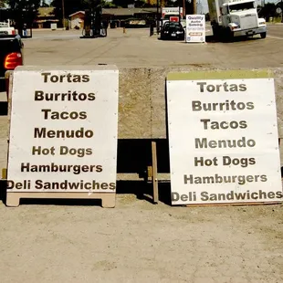 two signs in a parking lot
