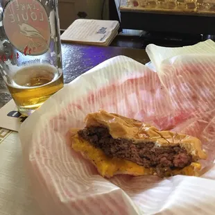 a cheeseburger and a glass of beer