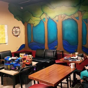 Neat mural and nook that is great for moms trying meet up. There are toys and games for kids! On the left you can see the roaster!