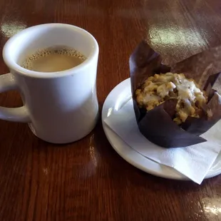 Pumpkin muffin and some dark coffee. Dark coffee light flavor. The muffin is moist with a healthy glaze a top.