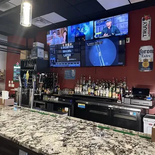 a bar with multiple televisions