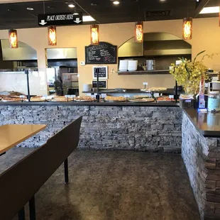 Front right of entrance where order by slice pizzas are and cashier area.