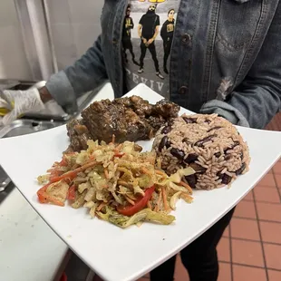 a person holding a plate of food