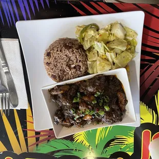 Ox tail with rice and peas and warm cabbage salad