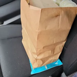 a paper bag in the back seat of a car
