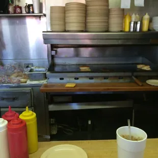 Sitting on the bar in front of the grill.