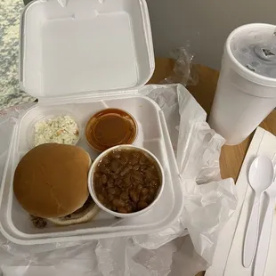 Brisket sandwich, coleslaw baked beans, bbq sauce, and sweet tea.