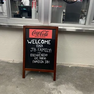 a welcome sign in front of a restaurant