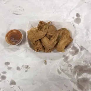 a plate of fried chicken with a side of ketchup