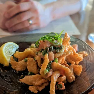 The famous calamari with lemon butter sauce, capers, tomatoes, green onions