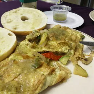 One of a kind Homestyle Veggie Omelette with home made salsa verde and buttered bagle. Wow.