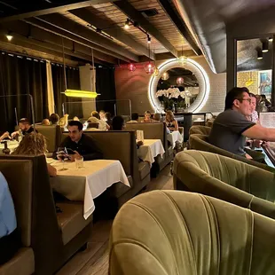 a group of people sitting at a table in a restaurant