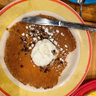 a plate of pancakes with whipped cream