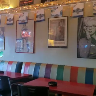 A wall of booth, opposite the bar.