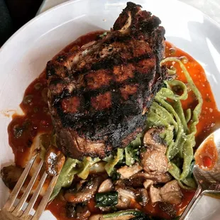Veal chop over spinach pasta