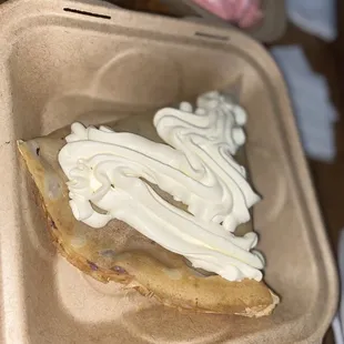 a pastry in a styrofoam container