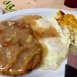 Chicken fried steak, green chili, over easy, and browns.