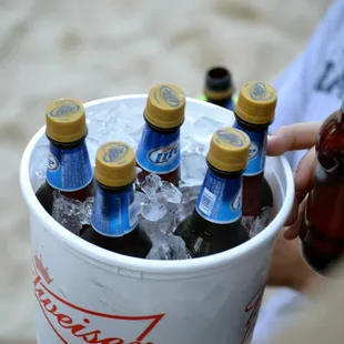  a person holding a bucket of beer