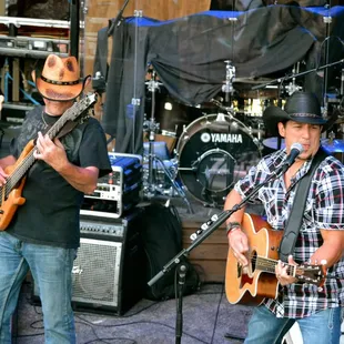  two men playing guitar and singing