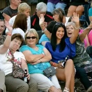  a group of people sitting in a crowd