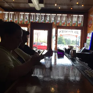  a woman sitting at a bar